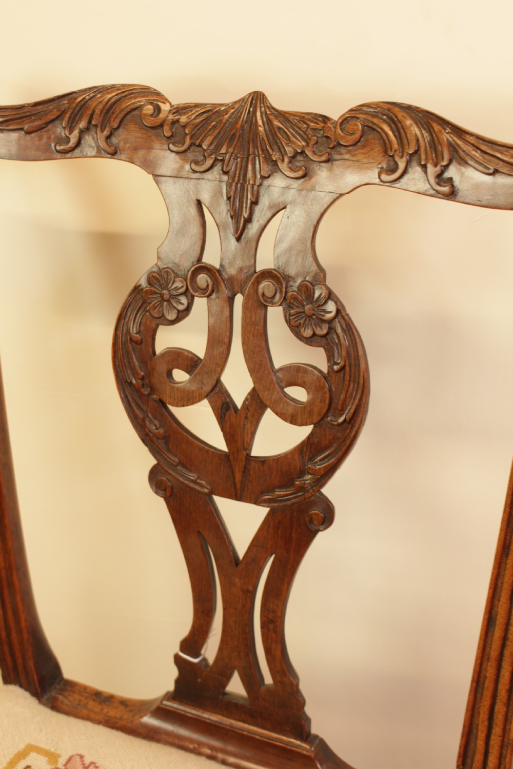 An 18th-century Chippendale-style carved mahogany side chair featuring a pierced back splat and a cream needlepoint tapestry seat. View V