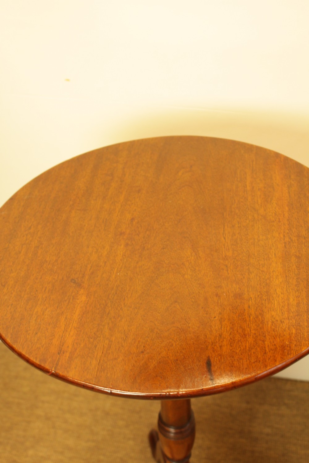 A George III period circular mahogany tilt-top table with a turned central column and tripod cabriole legs. View VII