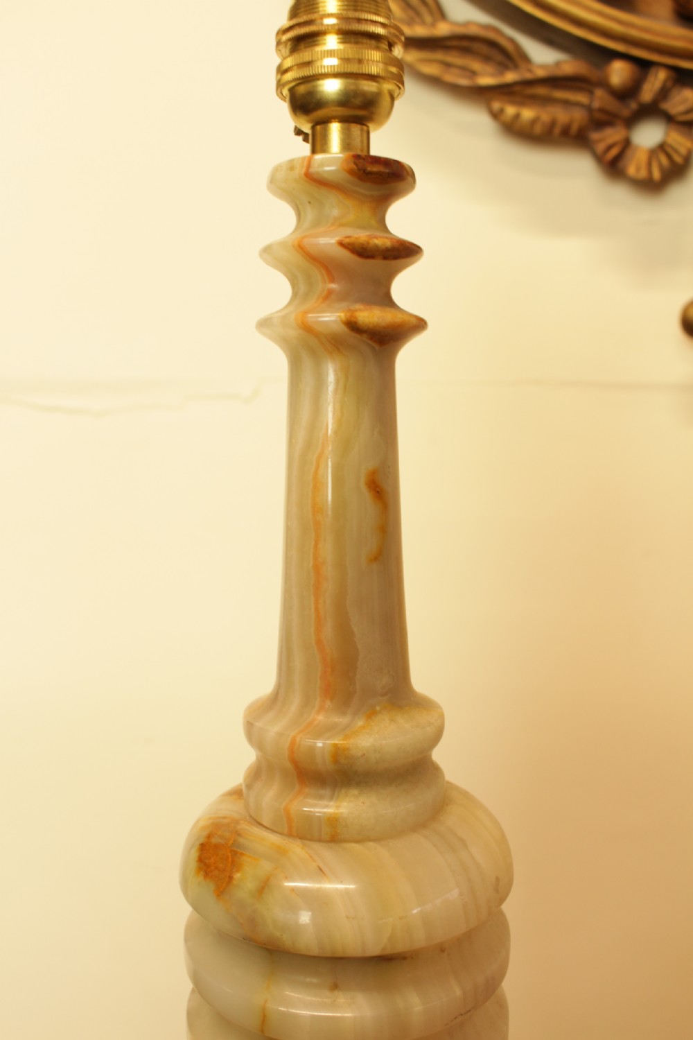 A 1930s Italian table lamp featuring a turned, veined onyx stone column and a pleated cream lampshade. View IV