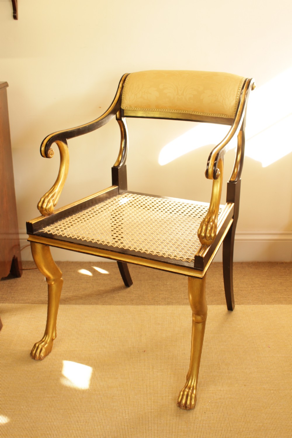 A Gilt & Ebonies Cane Open Arm Chair 