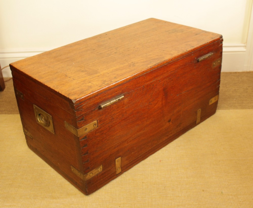 A rectangular warm brown camphorwood storage trunk featuring brass corner straps, hand-cut dovetail joints, and a central keyhole. View II