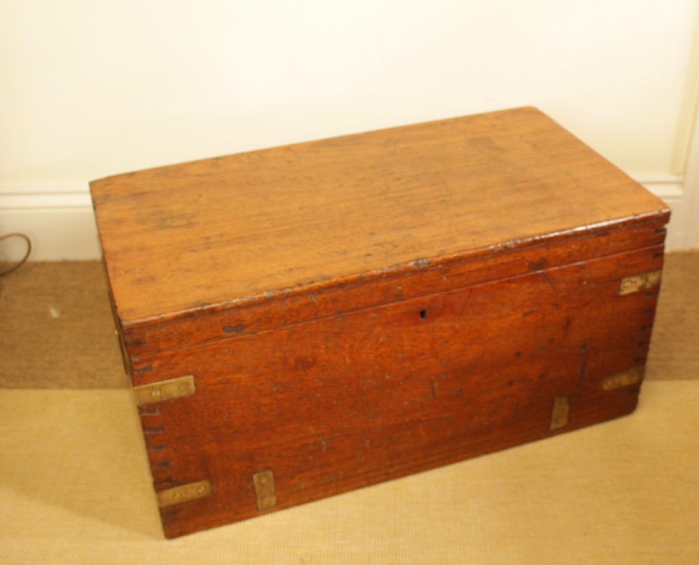 A rectangular warm brown camphorwood storage trunk featuring brass corner straps, hand-cut dovetail joints, and a central keyhole. View III
