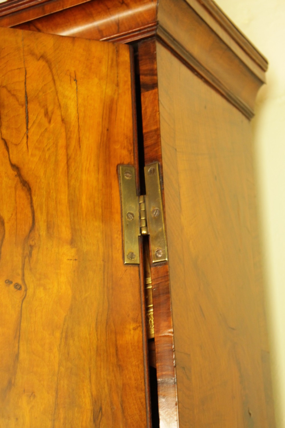 An eighteenth-century walnut bureau bookcase featuring two cupboard doors over a slant-front writing flap with four lower drawers and brass handles. View VI
