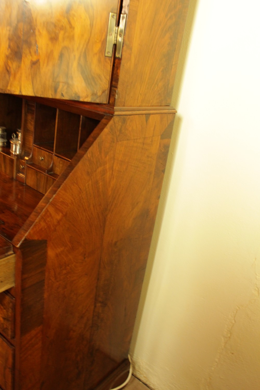 An eighteenth-century walnut bureau bookcase featuring two cupboard doors over a slant-front writing flap with four lower drawers and brass handles. View VIII