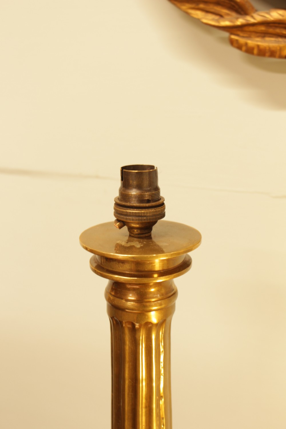 A solid brass table lamp base designed in the form of a fluted classical column on a stepped square plinth. View III