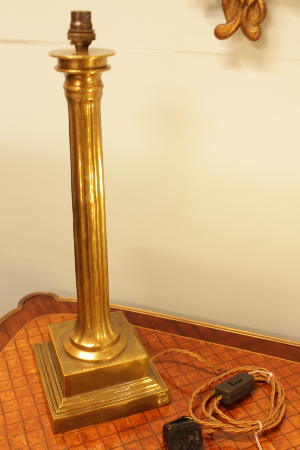 A solid brass table lamp base designed in the form of a fluted classical column on a stepped square plinth. View IV