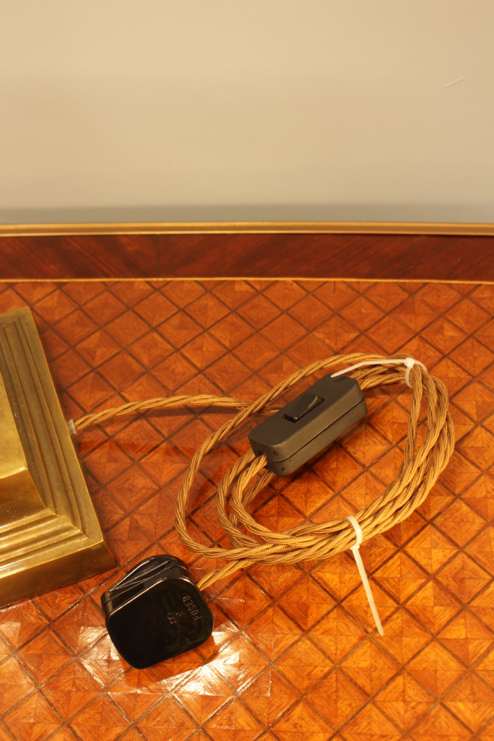 A solid brass table lamp base designed in the form of a fluted classical column on a stepped square plinth. View VII