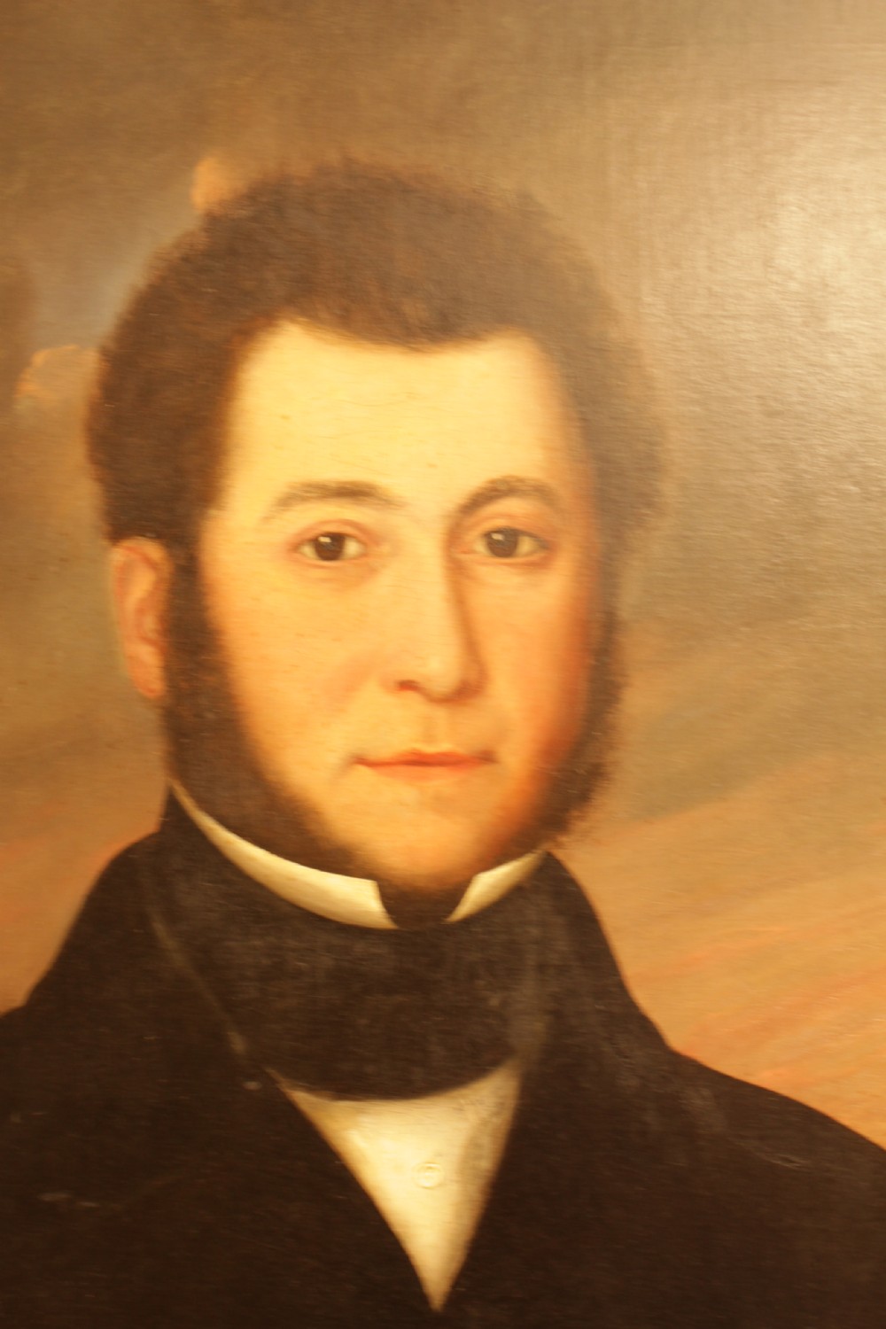 A 19th-century oil painting on canvas depicting a gentleman with sideburns wearing a dark coat and cravat. View II
