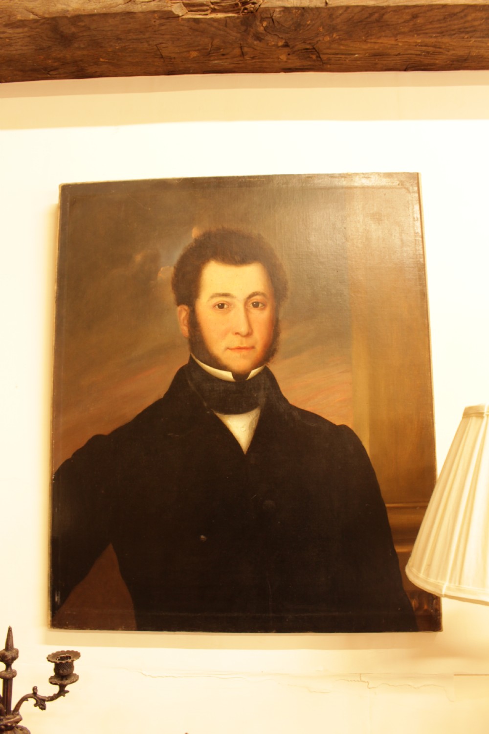 A 19th-century oil painting on canvas depicting a gentleman with sideburns wearing a dark coat and cravat. View V