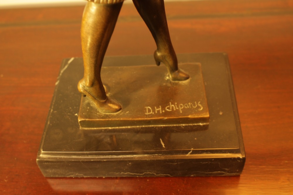 An Art Deco bronze sculpture depicting a stylized female dancer in a pleated dress and cloche headpiece mounted on a marble base. View IV