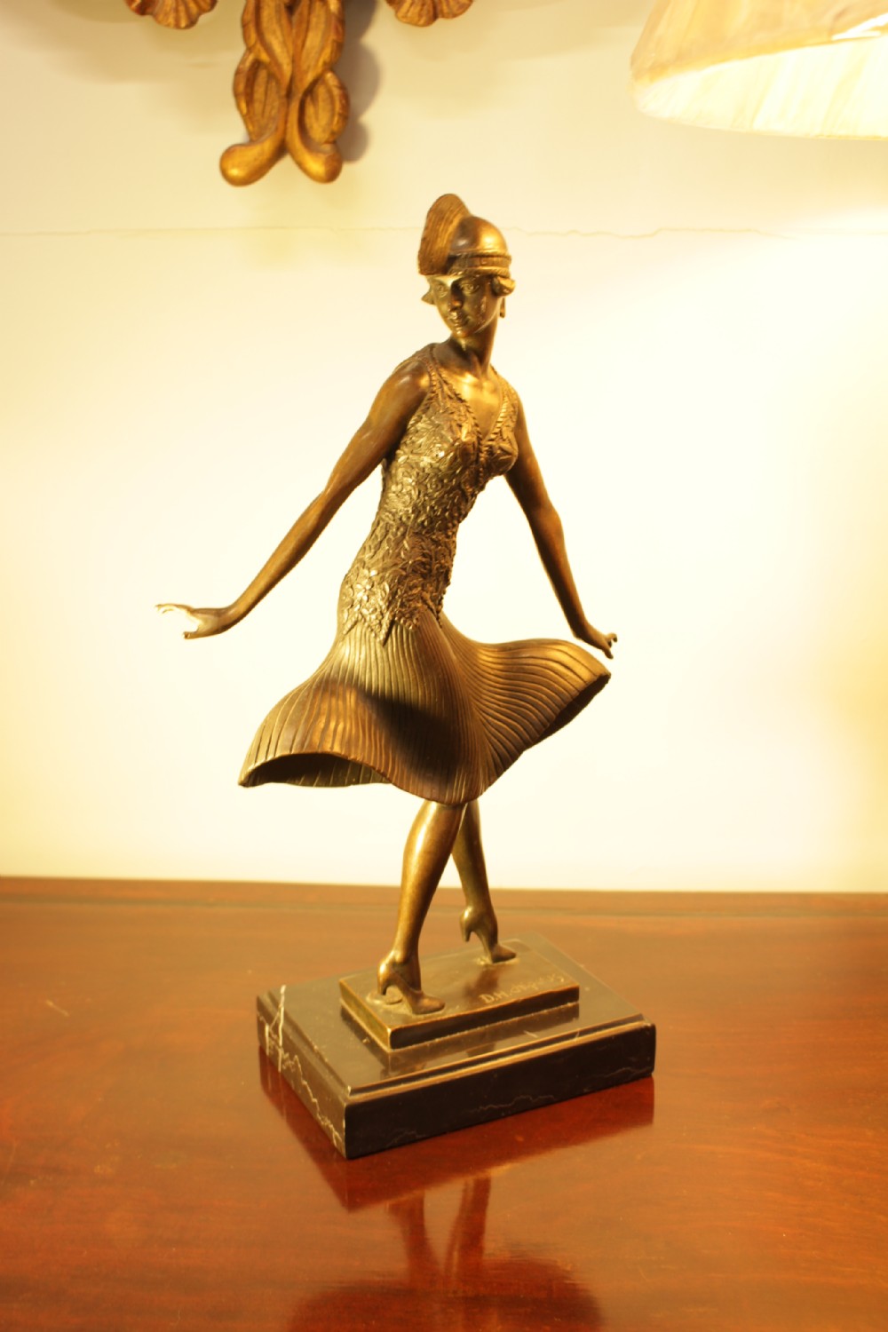 An Art Deco bronze sculpture depicting a stylized female dancer in a pleated dress and cloche headpiece mounted on a marble base. View XI