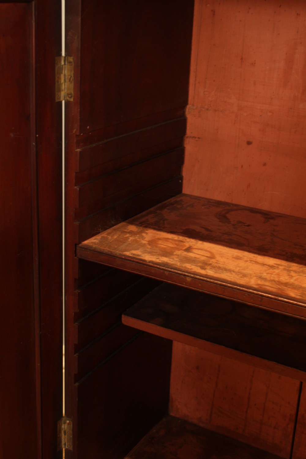 A Regency flame mahogany side cabinet featuring a two-door cupboard base below a tiered open shelf superstructure supported by slender turned columns. View III