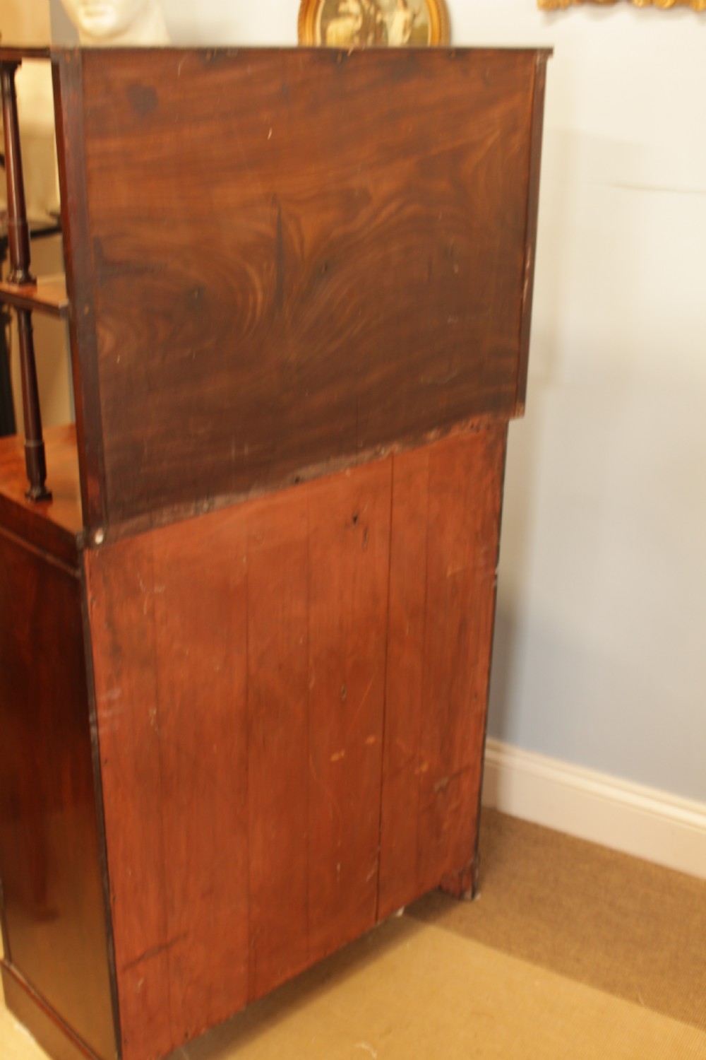 A Regency flame mahogany side cabinet featuring a two-door cupboard base below a tiered open shelf superstructure supported by slender turned columns. View IX
