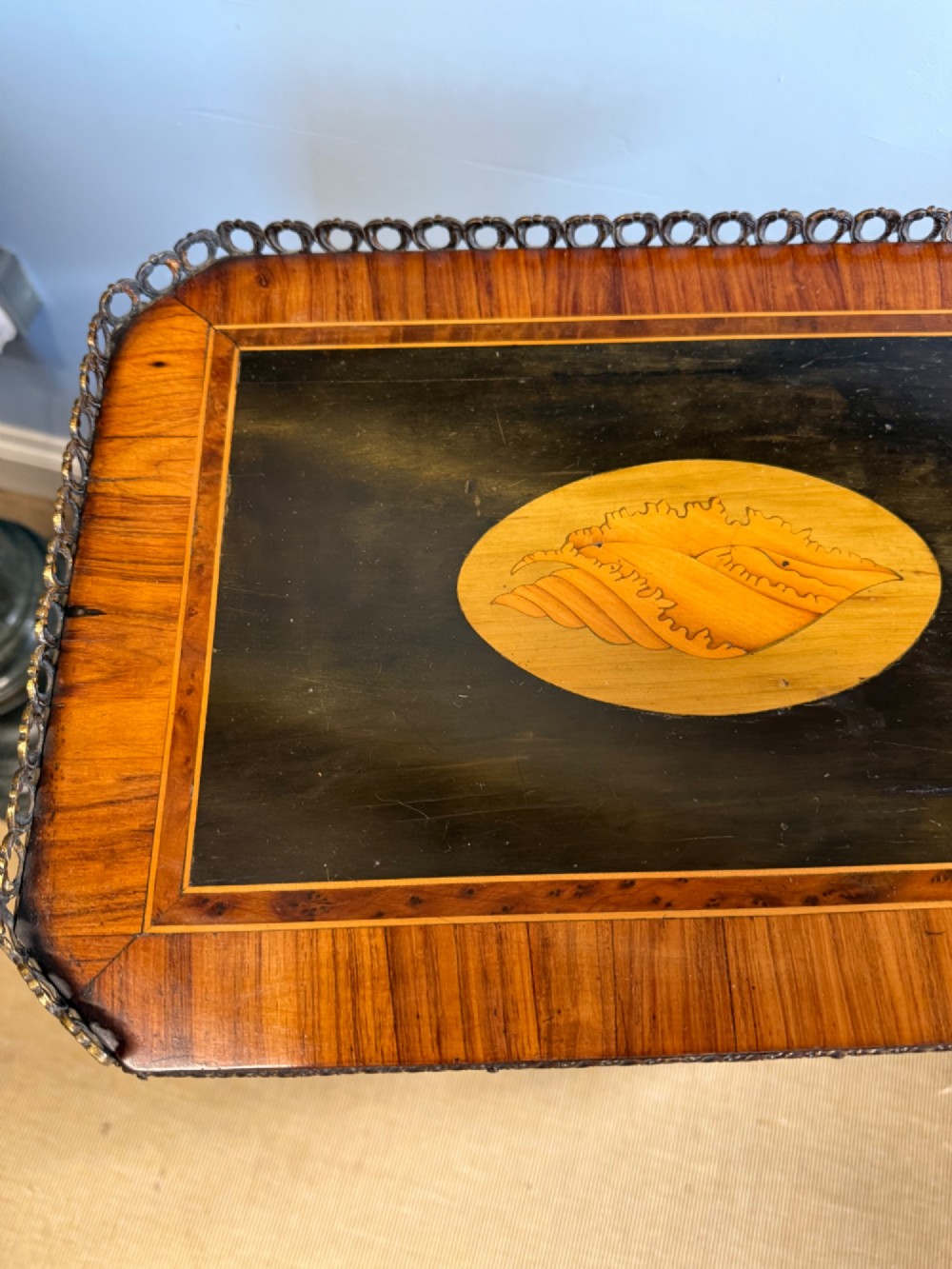 A three-tiered French ebonised walnut whatnot table with marquetry floral inlays, a single drawer, cabriole legs, and a pierced brass top gallery. View VII