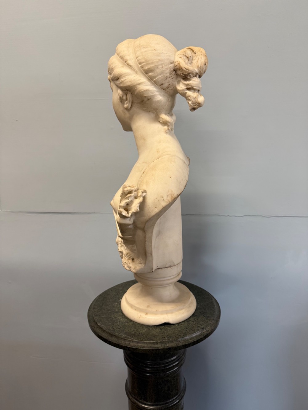 Carved white marble bust depicting Diana the Huntress with a quiver over her shoulder resting on a round moulded base. View V