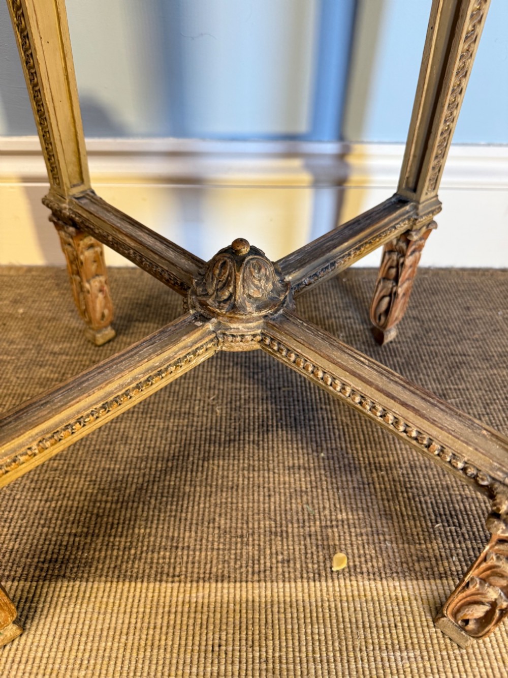 A tall 19th-century French Neoclassical style plant stand featuring a circular grey marble top, carved cream and parcel-gilded legs with swags, and a central X-stretcher. View V