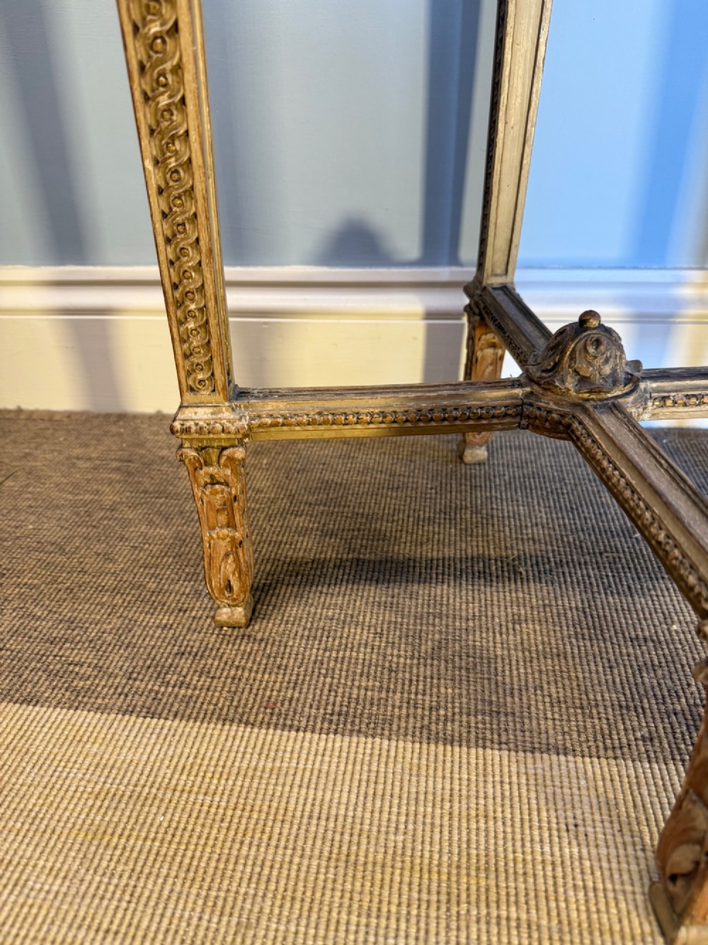A tall 19th-century French Neoclassical style plant stand featuring a circular grey marble top, carved cream and parcel-gilded legs with swags, and a central X-stretcher. View VIII