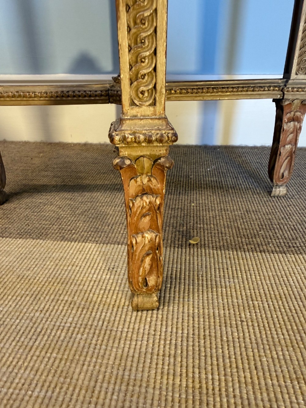 A tall 19th-century French Neoclassical style plant stand featuring a circular grey marble top, carved cream and parcel-gilded legs with swags, and a central X-stretcher. View IX