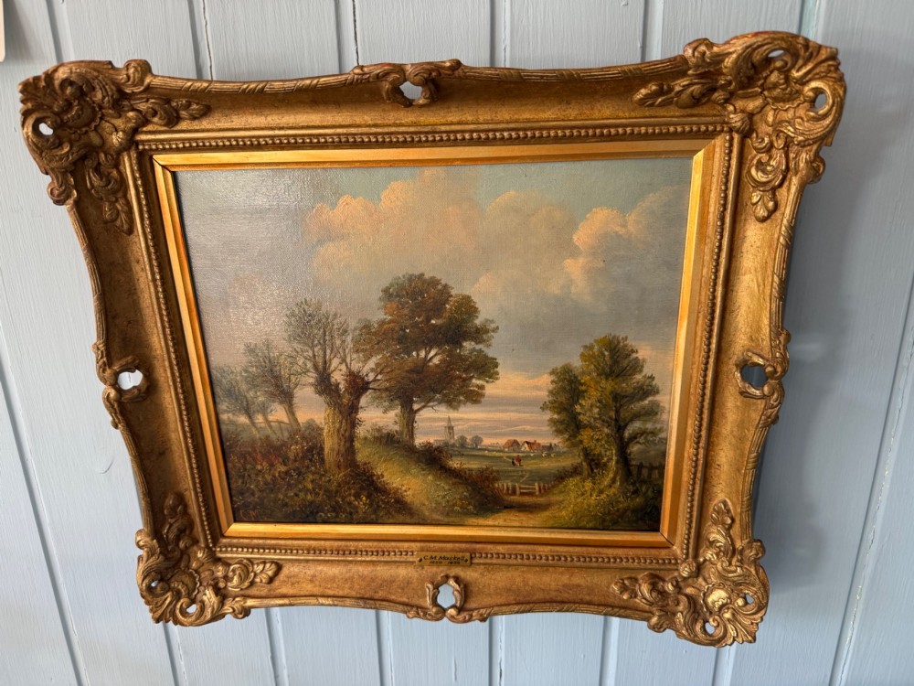 An antique Victorian oil painting on canvas depicting a rural English countryside scene set within an ornate gilded frame.