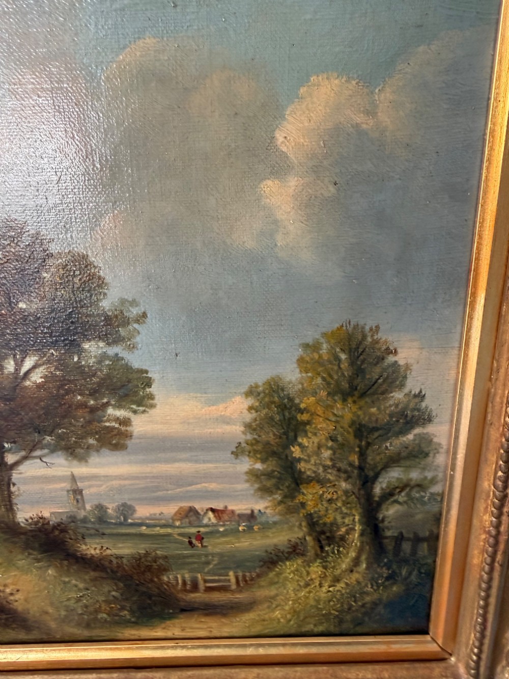 An antique Victorian oil painting on canvas depicting a rural English countryside scene set within an ornate gilded frame. View III