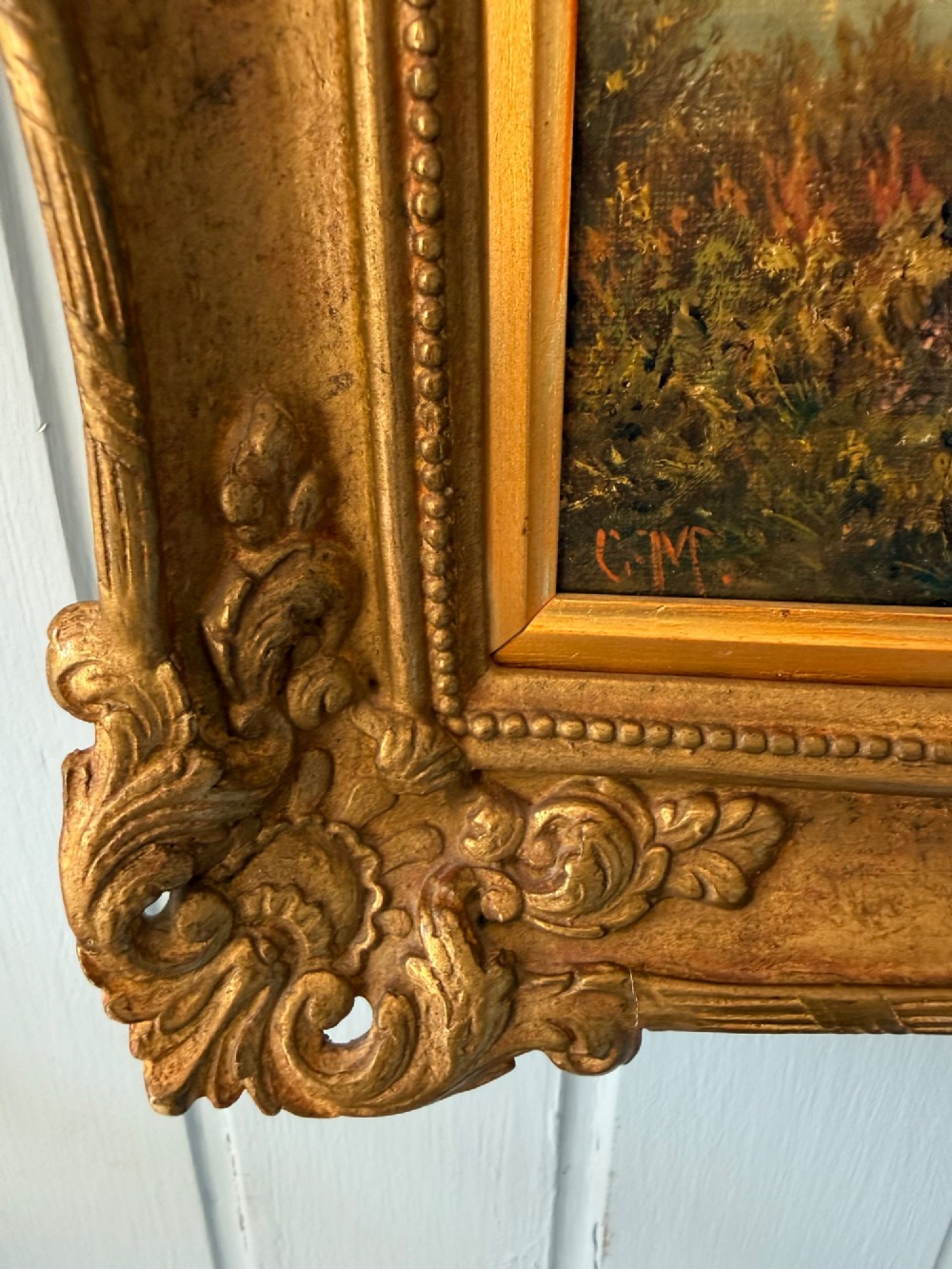 An antique Victorian oil painting on canvas depicting a rural English countryside scene set within an ornate gilded frame. View VI
