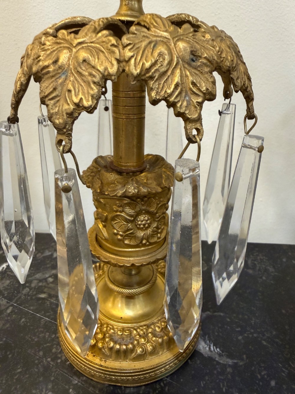 A pair of 19th-century gilt bronze ormolu candlesticks featuring acanthus leaf crowns and suspended clear crystal prism lustres. View III