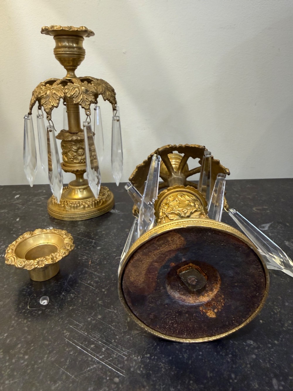 A pair of 19th-century gilt bronze ormolu candlesticks featuring acanthus leaf crowns and suspended clear crystal prism lustres. View VI