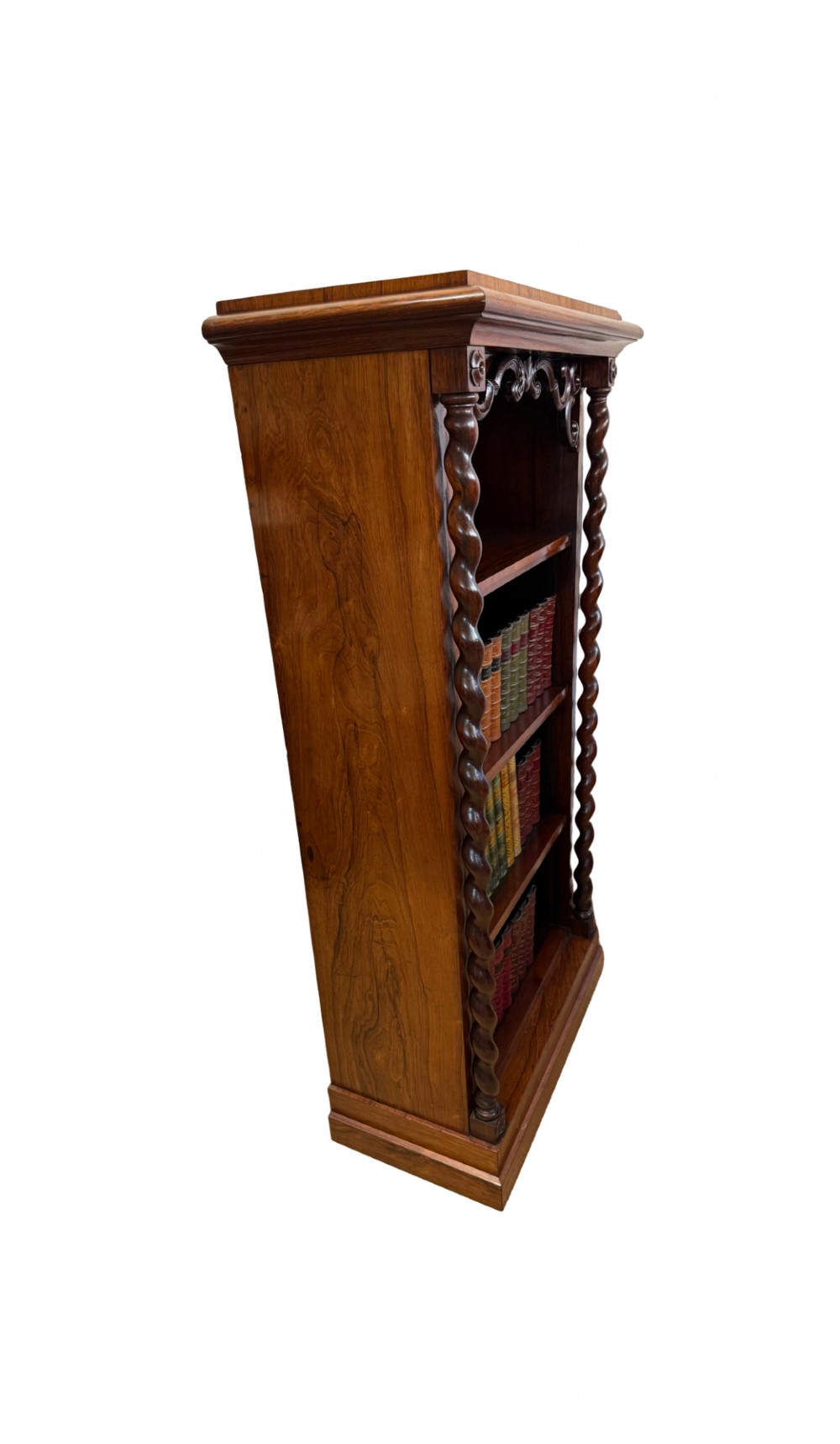 A 19th-century Victorian rosewood open bookcase featuring four open shelves flanked by barley twist pilasters and topped with carved scrollwork. View VI
