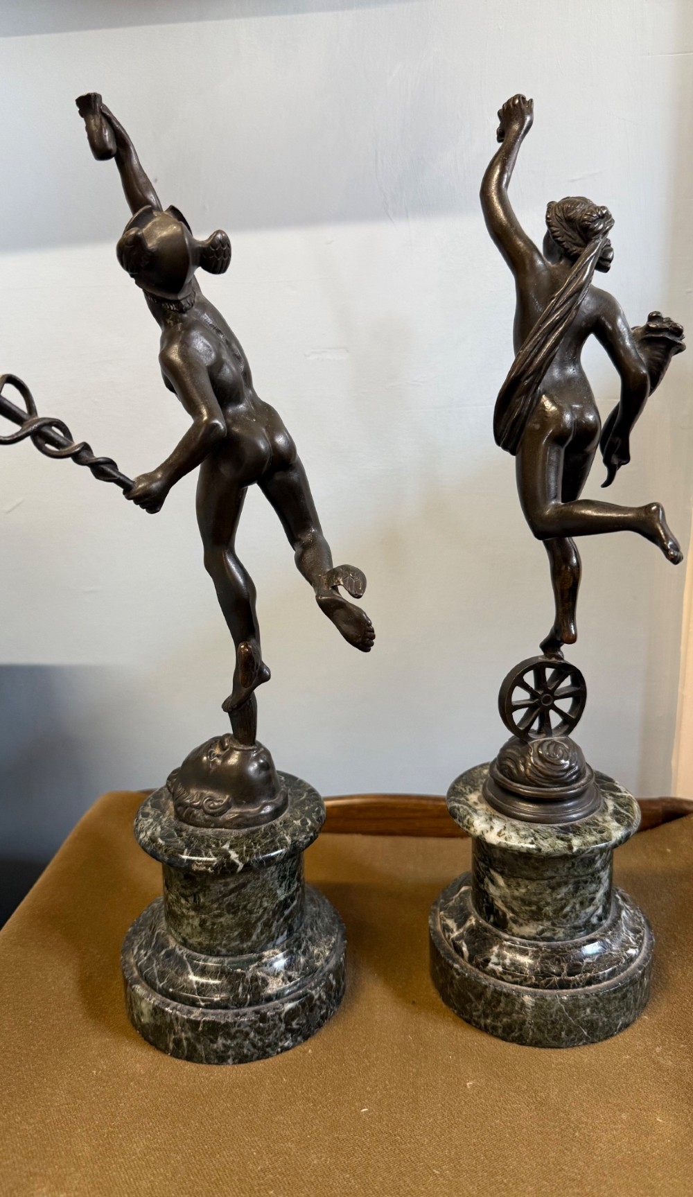 A pair of dark bronze Neoclassical figures depicting Mercury and Fortuna mounted on cylindrical green marble pedestals. View VIII