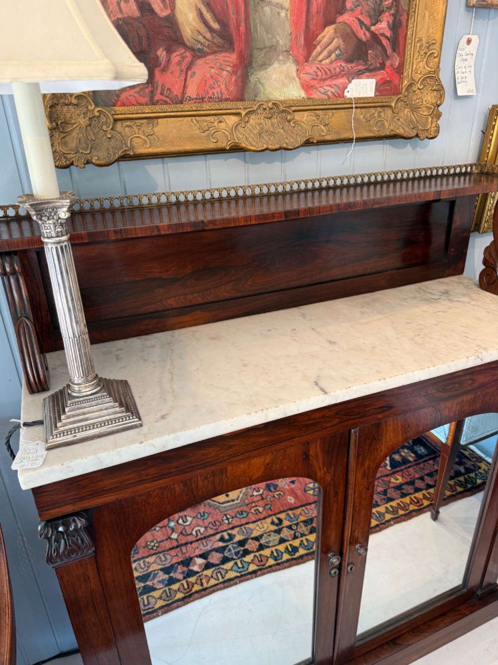 A nineteenth-century dark rosewood chiffonier featuring a white marble top surface, twin mirrored door panels, and a raised upper shelf with brass gallery detailing. View II