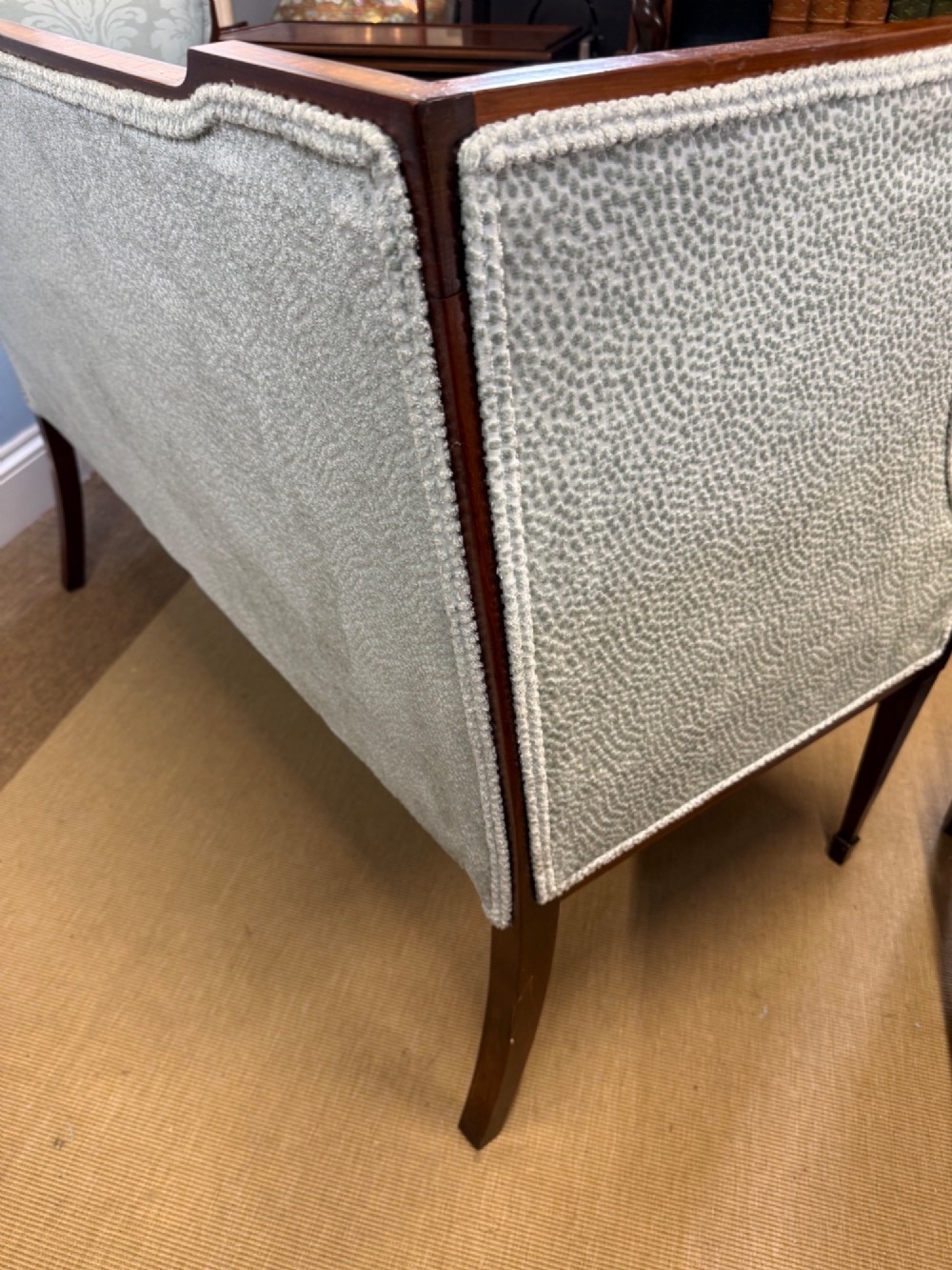 An Edwardian two-seater mahogany sofa upholstered in light blue damask fabric with satinwood crossbanding along the frame. View VII