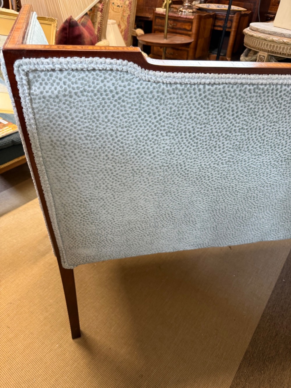 An Edwardian two-seater mahogany sofa upholstered in light blue damask fabric with satinwood crossbanding along the frame. View VIII