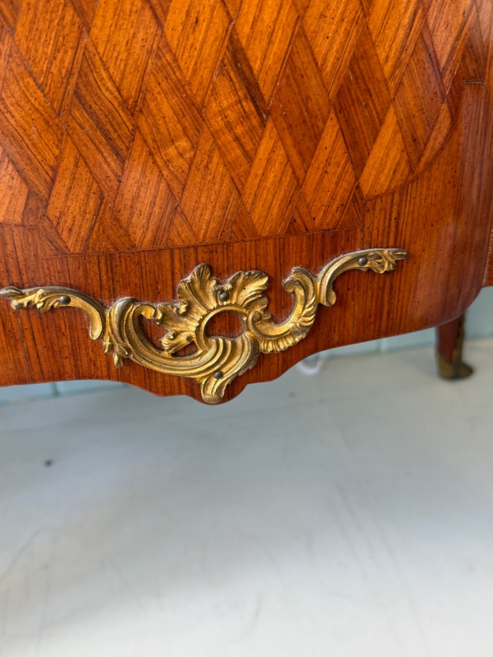 A mid 19th-century French commode featuring a marble top, parquetry wood veneer, two drawers with gilt bronze handles, and cabriole legs. View VII