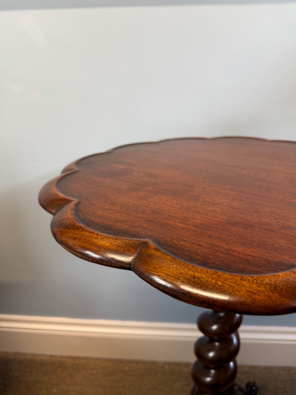 A 19th-century mahogany tripod side table featuring a scalloped piecrust edge top, a spiral barley twist column stem, and carved cabriole legs. View V