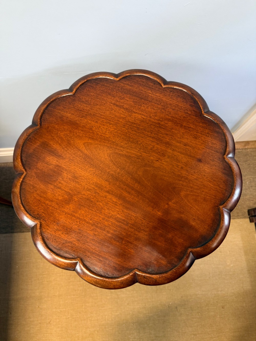 A 19th-century mahogany tripod side table featuring a scalloped piecrust edge top, a spiral barley twist column stem, and carved cabriole legs. View VI