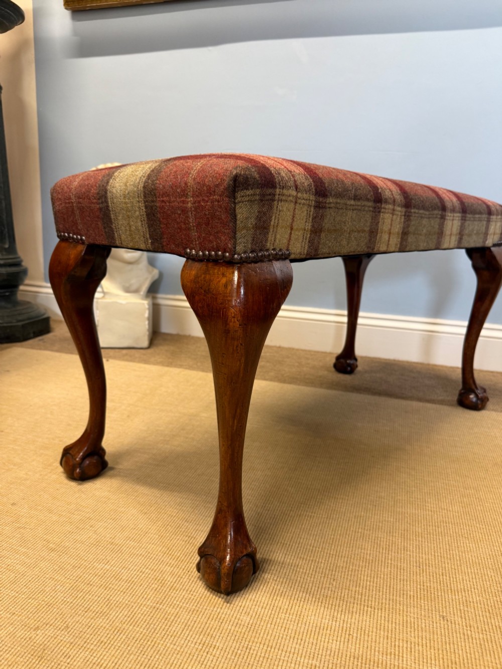 A rectangular mahogany stool featuring tartan wool upholstery, stud trim, cabriole legs, and ball and claw feet. View IV