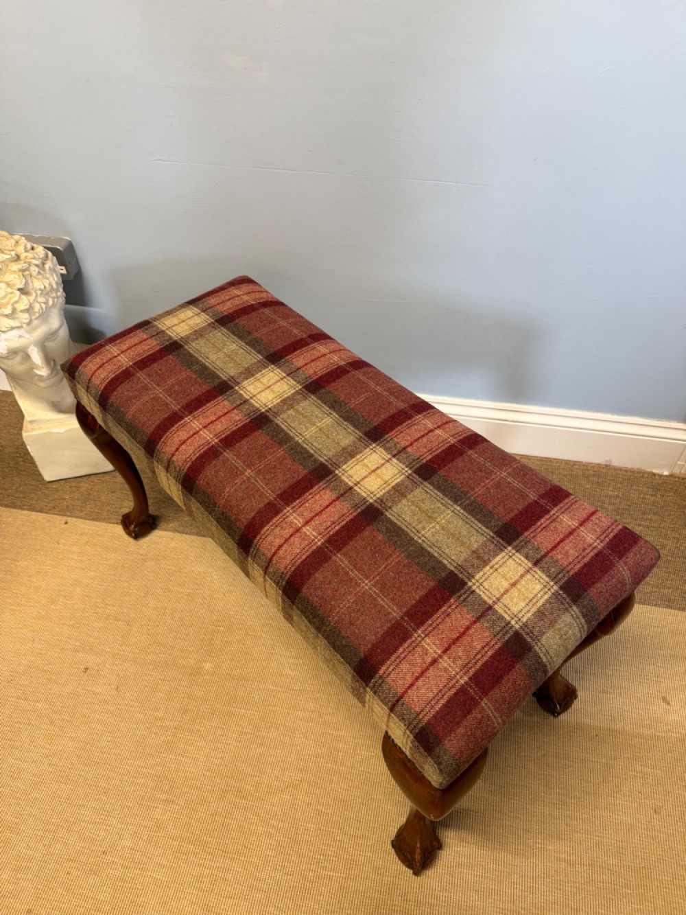 A rectangular mahogany stool featuring tartan wool upholstery, stud trim, cabriole legs, and ball and claw feet. View V
