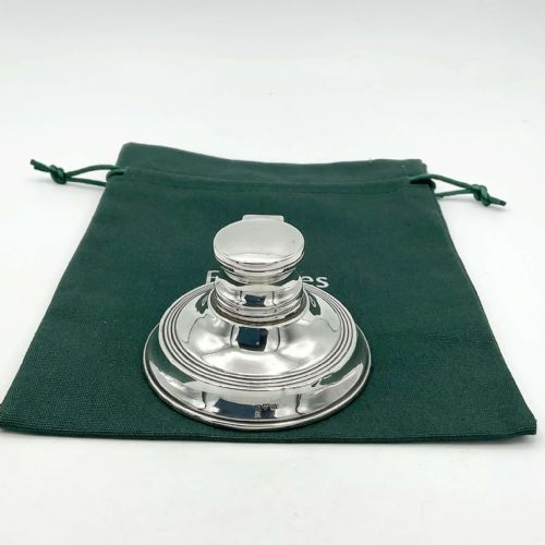 fig 1. An antique circular sterling silver capstan inkwell with a open hinged lid and visible British hallmarks.