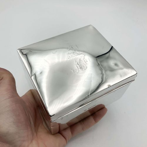 fig 1. A square sterling silver box with a slightly domed lid, engraved monogram, and visible hallmark stamps on the front edge.