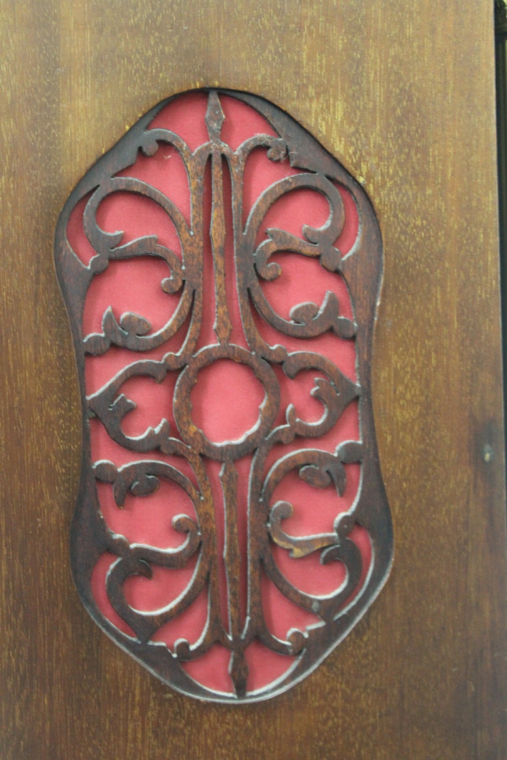 A dark mahogany Edwardian bracket clock featuring brass column supports, pineapple finials, and an ornate silvered dial with subsidiary chime indicators. View VII