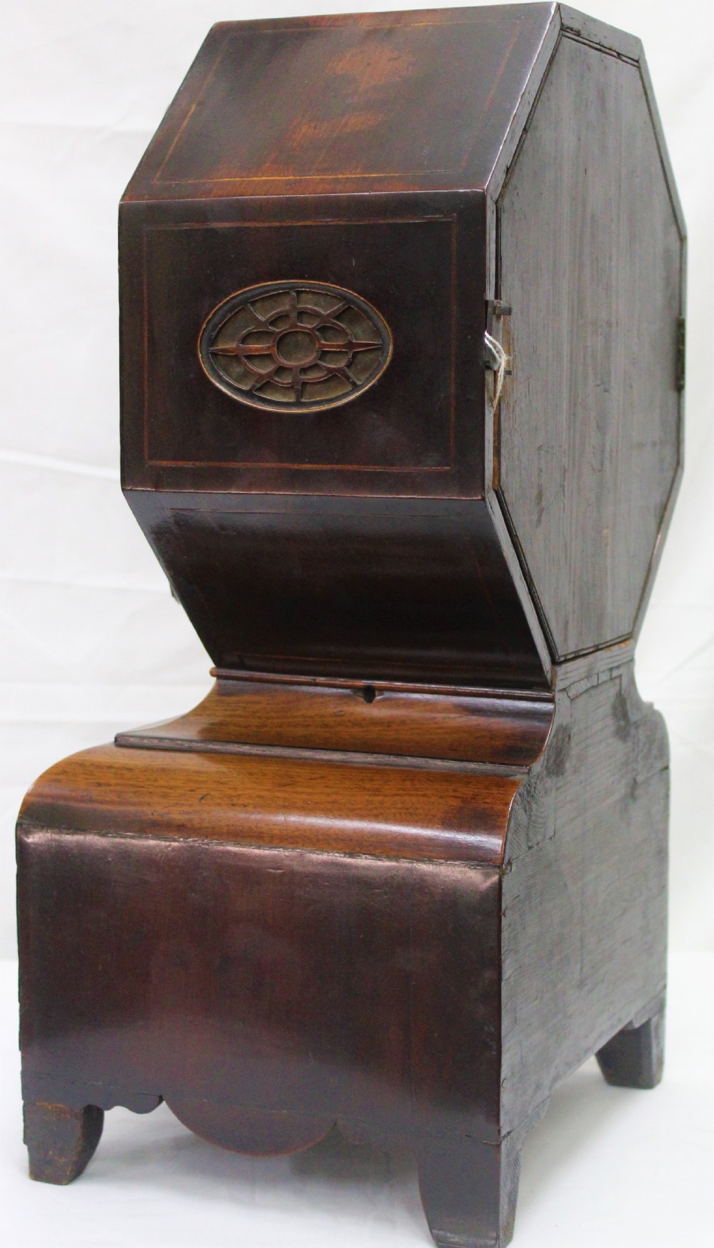 An antique Scottish mahogany mantel clock featuring an octagonal upper head enclosing a cream painted dial with Roman numerals, set on a moulded base with bracket feet. View III