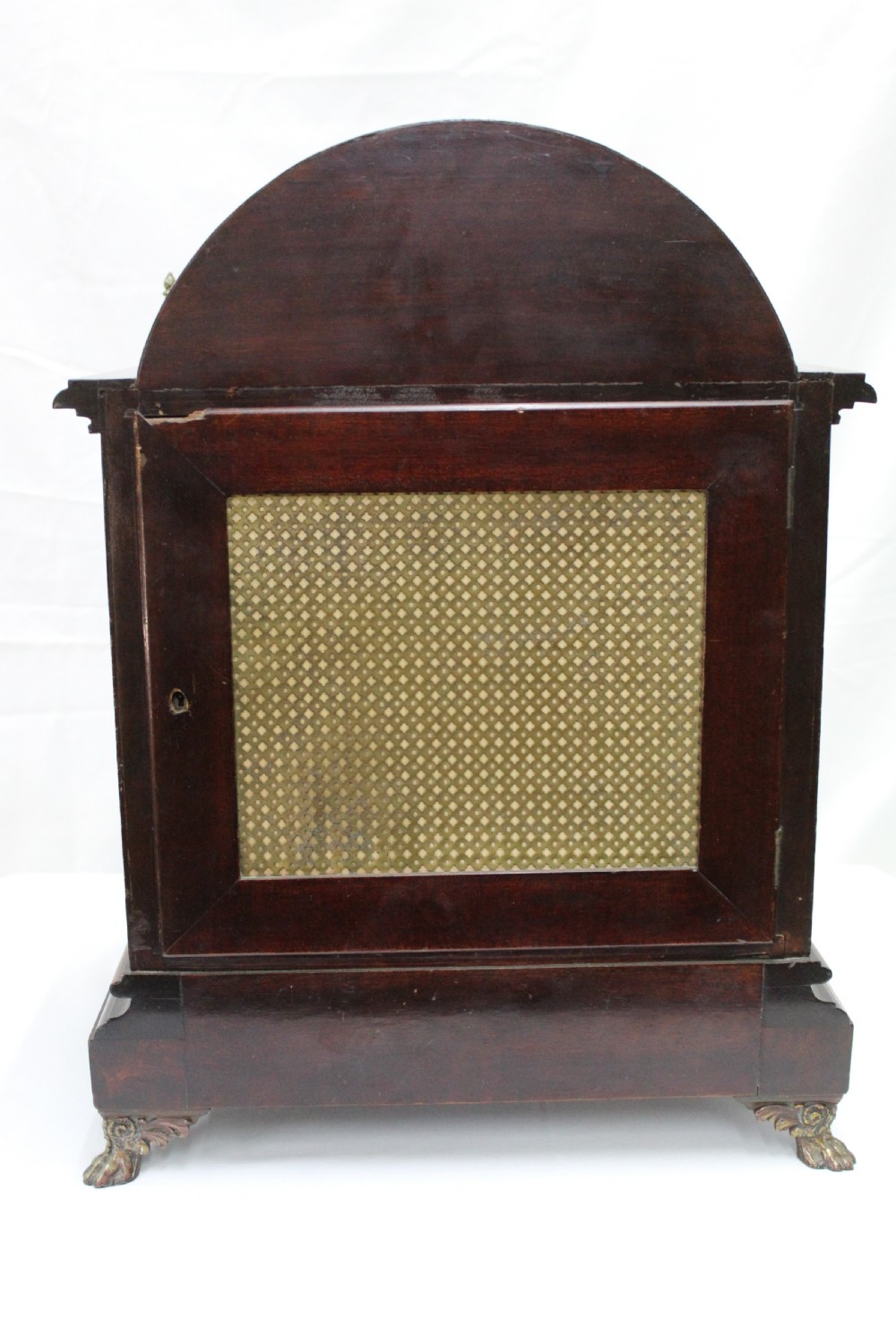 An arched mahogany bracket clock featuring brass spandrels, subsidiary dials, a silvered chapter ring, and brass bracket feet. View IX