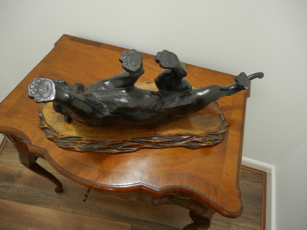 A dark bronze Japanese tiger sculpture depicted in a roaring, prowling stance mounted on a carved wooden base. View V