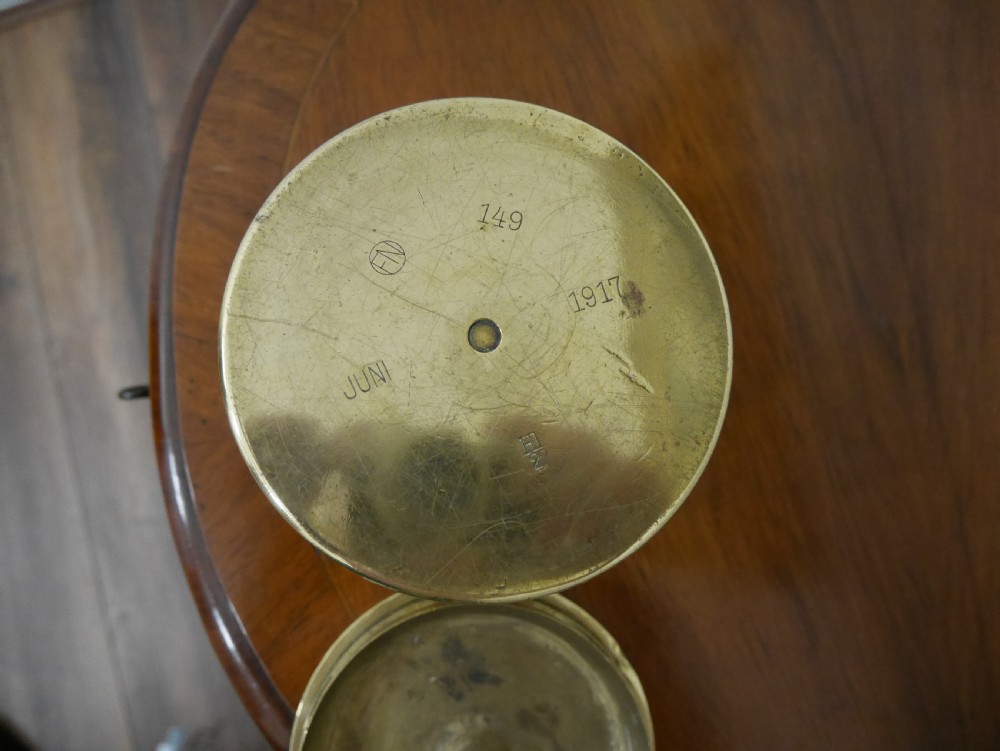 A cylindrical brass artillery shell casing converted into a lidded container with silver and copper Middle Eastern calligraphy inlays. View VI