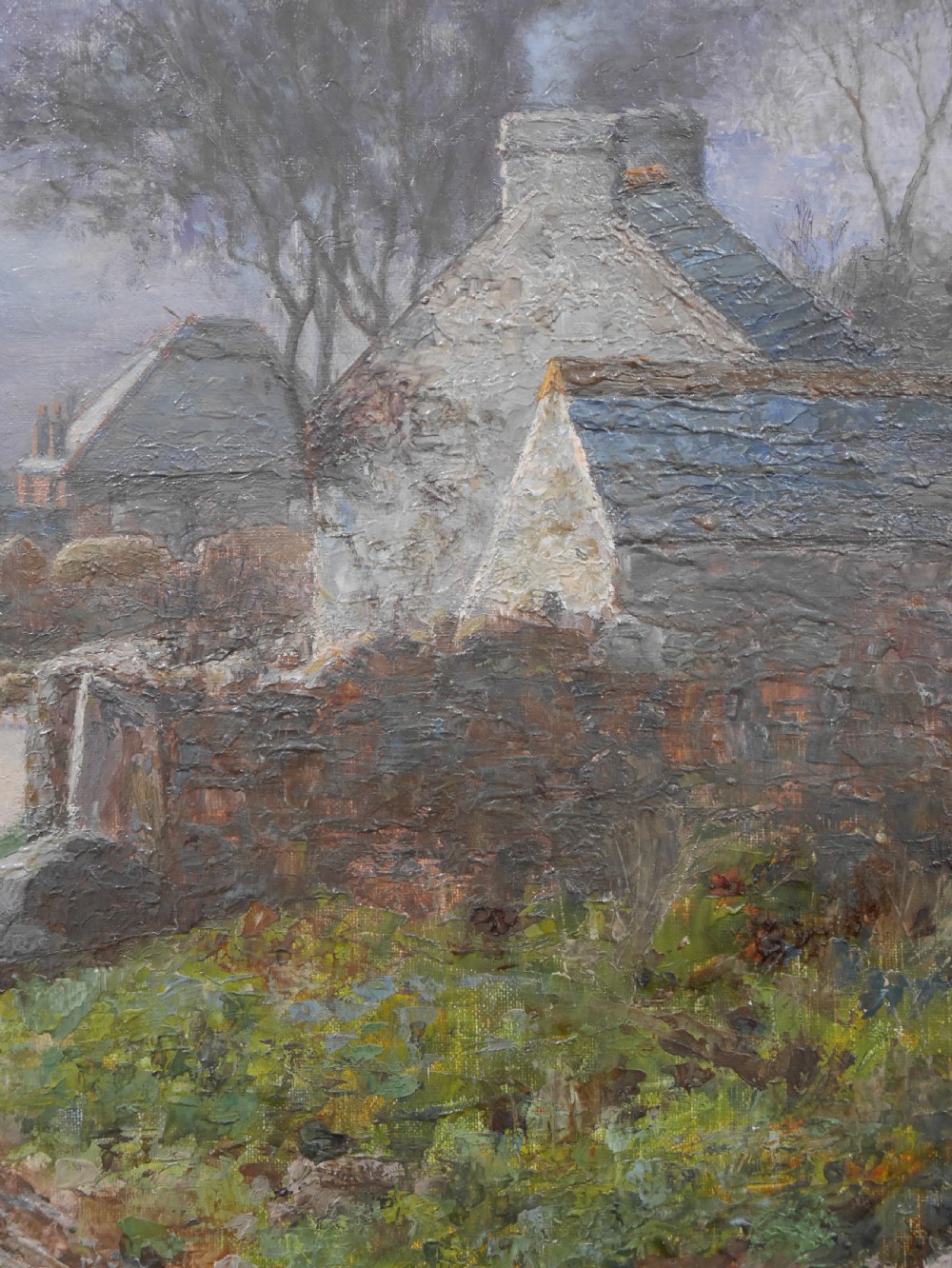 An antique oil painting on canvas depicting a rural stone cottage along a dirt path set in an ornate carved giltwood frame. View IV