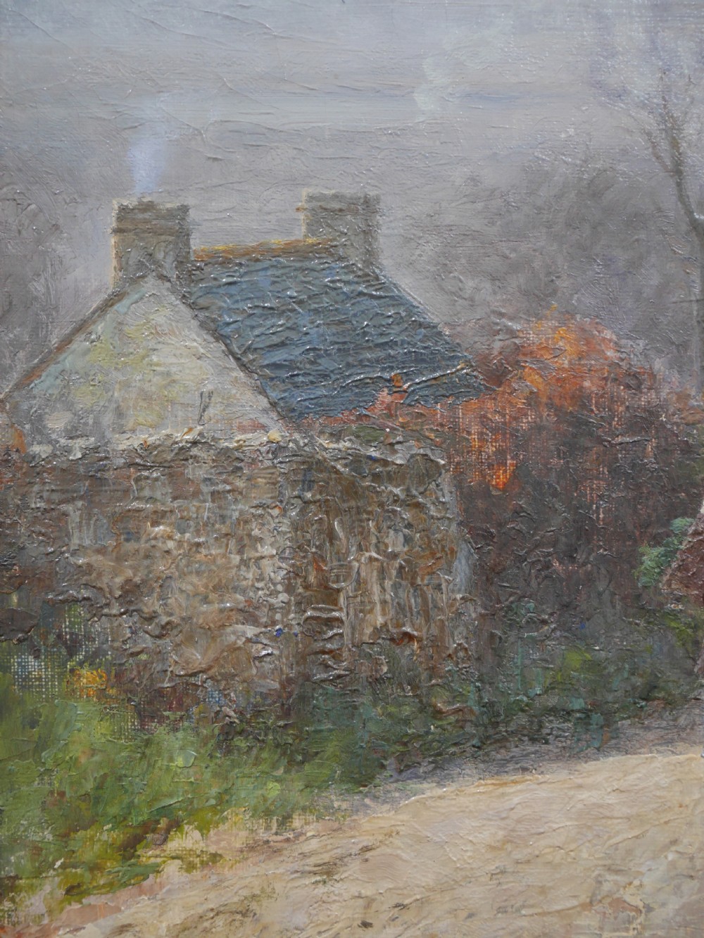An antique oil painting on canvas depicting a rural stone cottage along a dirt path set in an ornate carved giltwood frame. View V