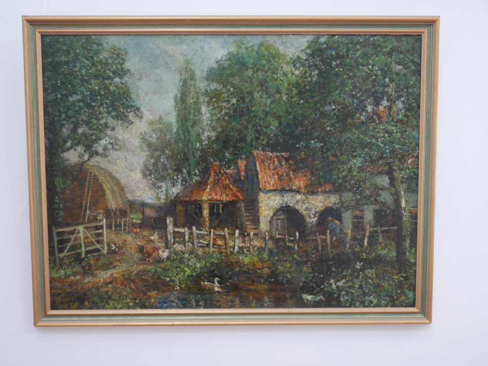 An impressionist oil painting on board depicting a rural farmyard scene with stone outbuildings, red tiled roofs, surrounding trees, and ducks near a pond in a slim gilt frame.