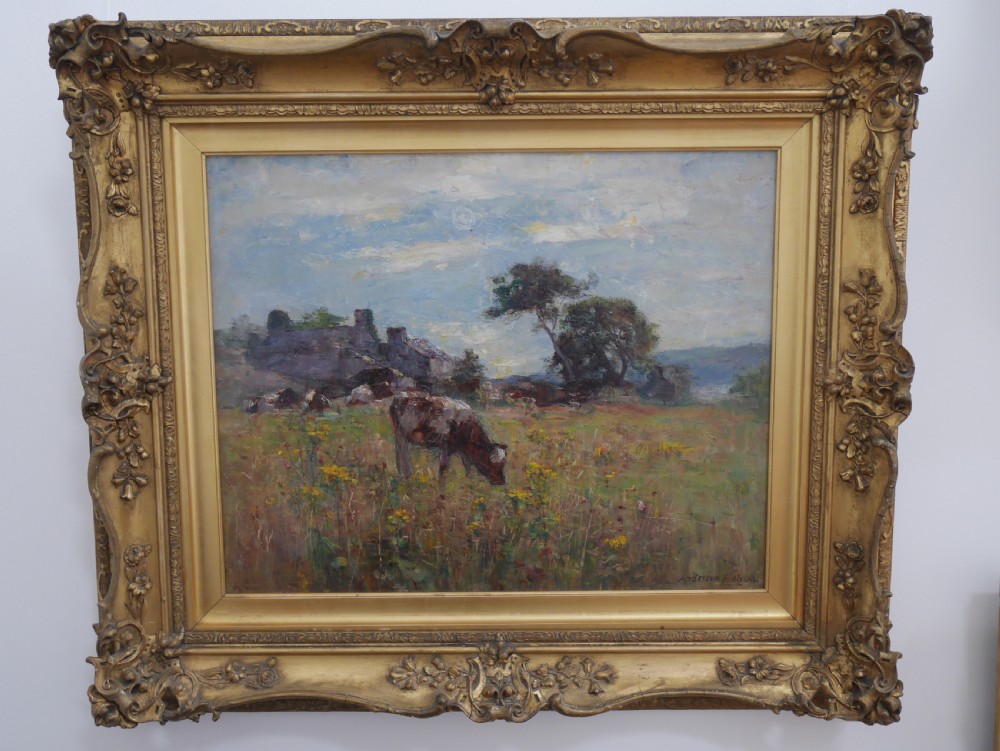 An oil painting depicting cattle grazing in a green pastoral field, set within an ornate gilded wooden frame.