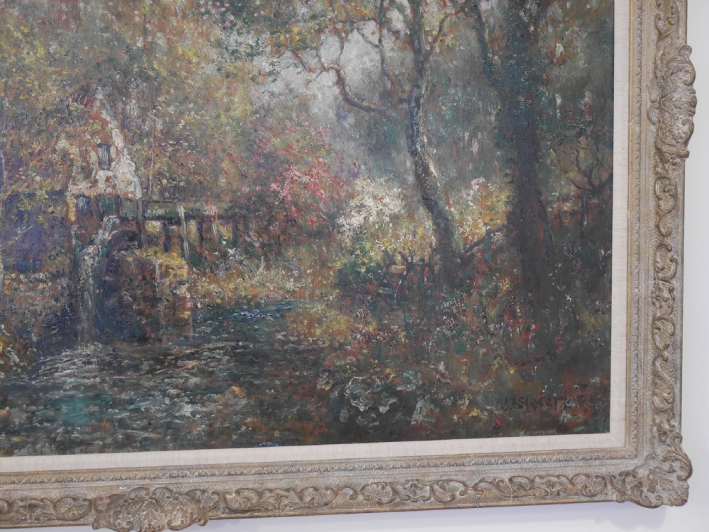 An antique impressionist oil painting on board depicting a wooded landscape with a stream and cottage in an embellished gilt frame. View III