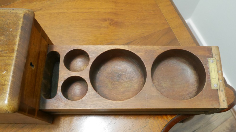 An open mahogany Gledhill patent cash till showing internal mechanical brass parts, a paper roll mechanism, and a printed paper instruction label on the underside of the lid. View III
